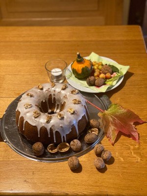 Gugelhupf mit Zuckerguss und Herbstdekoration